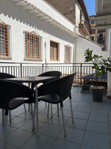 a table and chairs on top of a balcony at IRUÑA ROOMs in Pamplona