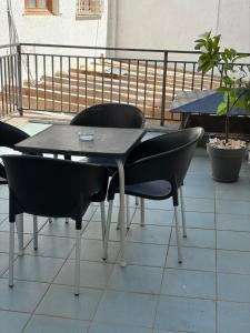 a table and chairs sitting on top of a balcony at IRUÑA ROOMs in Pamplona