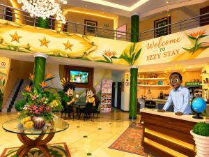 a lobby of a hotel with a welcome to tea shop at Hotel Izzy Stay in Maputo +41 photos