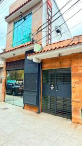 a building with two garage doors on a street at Ninho Moderno in Volta Redonda +6 photos