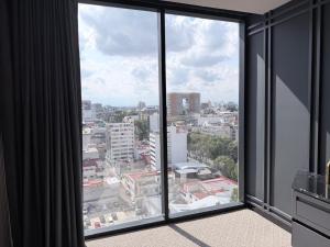 a view of a city from a large window at PISO 13 SM Living Street Mall in Puebla