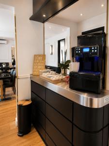 a kitchen with a counter with a microwave at Hôtel Gallia Cannes in Cannes
