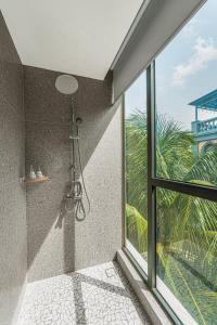 a shower in a bathroom with a window at Maison Thu in Phú Quốc +43 photos