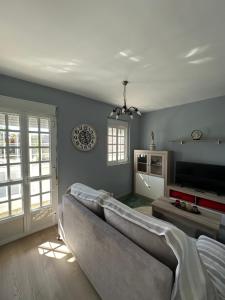 a living room with a couch and a tv at Casa da Xueza in Vales