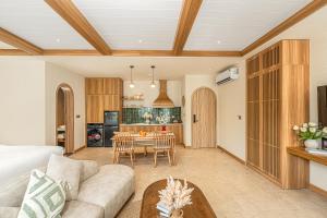 a living room with a couch and a table at Maison Thu in Phú Quốc
