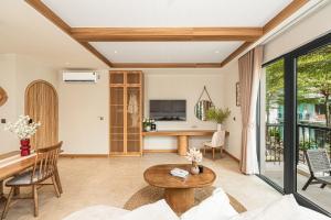 a living room with a couch and a table at Maison Thu in Phú Quốc