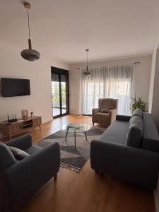 a living room with two couches and a table at Apartment 22 - calm location in Bar