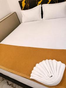 a bed with a white pillow sitting on it at Global Residency in Palakkad