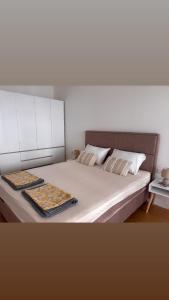 a bedroom with a large bed with two trays on it at Apartment 22 - calm location in Bar