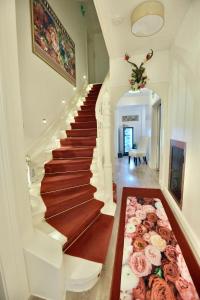 a staircase in a house with roses on the floor at Boutiquehotel Villa Rosenhof in Badenweiler