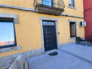 a door on the side of a building at Casa Stone in Guarda +4 photos
