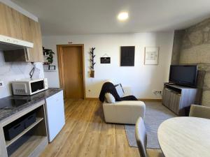 a living room with a couch and a microwave at Casa Stone in Guarda