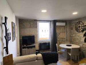 a living room with a couch and a table at Casa Stone in Guarda