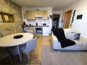 a living room with a white couch and a table at Casa Stone in Guarda