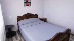 a small bedroom with a bed and a stool at Rokiti Yard in Bagdatʼi +16 photos