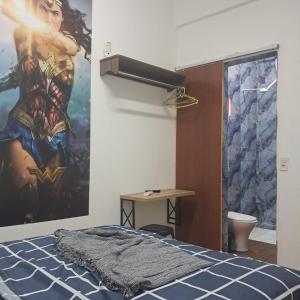 a bedroom with a superhero mural on the wall at Bem no Centro in Juazeiro do Norte