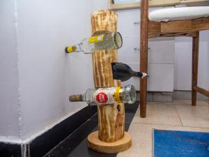 a fire hydrant with two wine bottles on it at Queen Tori in Malindi +10 photos