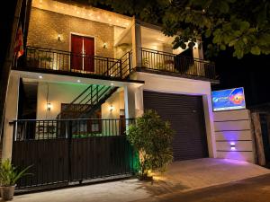 a large house with a garage at night at Skylurk Transit in Negombo