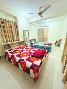 a bedroom with two beds and a ceiling at Ast Guest House in Dhaka