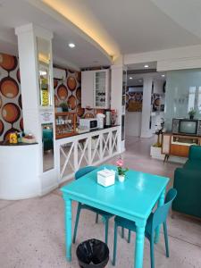 a blue table in a room with a kitchen at Happy 2 Pratunam Hotel in Bangkok