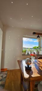 a living room with a wooden table and a window at Plutogatan PentHouse 