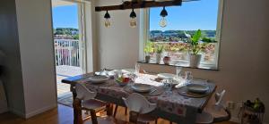 a dining room table with chairs and a tablecloth on it at Plutogatan PentHouse 