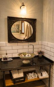 a bathroom with a sink and a mirror at סתיו בגולן in Qasrîne +37 photos