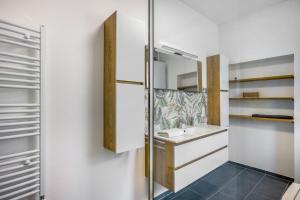 a bathroom with a sink and a mirror at Romy in Reischach +27 photos