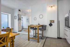 a kitchen and dining room with a table and chairs at Romy in Reischach