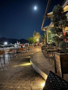 a patio with chairs and tables at night at The Old Winery in Aliveri