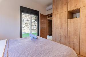 a bedroom with a bed and a large window at Echo 1-BR Apartment In Ejdabra Batroun 