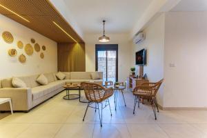 a living room with a couch and chairs at Echo 1-BR Apartment In Ejdabra Batroun 