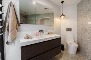 a bathroom with a sink and a toilet at The Graceful Dodeca Treehouse Coalcliff  +85 photos