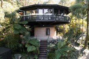 a house with a balcony on top of it at The Graceful Dodeca Treehouse Coalcliff 