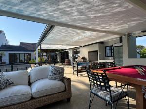 a living room with a couch and a table at Upper Constantia Entertainers dream! in Cape Town