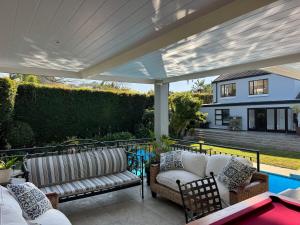 a patio with two couches and a table at Upper Constantia Entertainers dream! in Cape Town