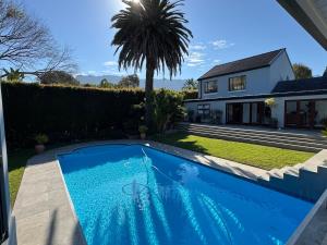 a swimming pool in the yard of a house at Upper Constantia Entertainers dream! in Cape Town