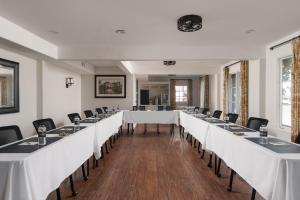 a row of tables in a room with white tables and chairs at The Milo in Santa Barbara +119 photos