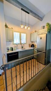a kitchen with a refrigerator and a counter top at Maison bord de mer - piscine - in Théoule-sur-Mer +21 photos