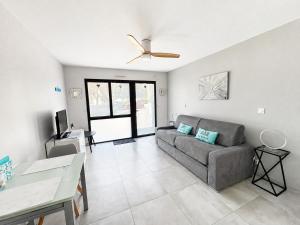 a living room with a couch and a table at Studio rez-de-jardin la Baule proche centre Pornichet in La Baule +9 photos