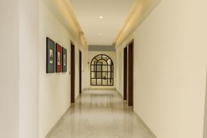 an empty hallway with white walls and a window at Oraka by My Downtown Aura Hotel in Udaipur