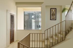 a staircase in a house with a large window at Oraka by My Downtown Aura Hotel in Udaipur