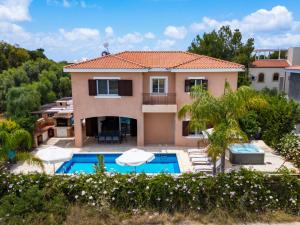 a villa with a swimming pool and a house at Villa Isla in Peyia