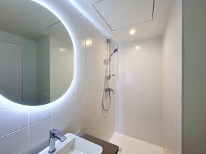 a bathroom with a sink and a shower with a mirror at Les Henrions in Pierrelatte +29 photos