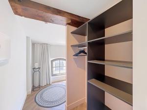 a walk in closet with black shelves at Maison 65 in Pierrelatte +73 photos