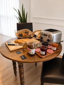 a table with a toaster and bread and a toaster at Hôtel Gallia Cannes in Cannes