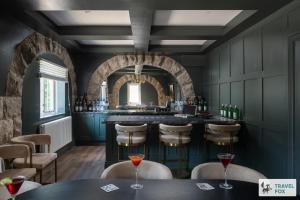 a bar in a restaurant with chairs and tables at The Plas - Rhosneigr Manor House in Rhosneigr