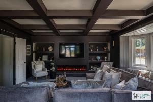 a living room with a couch and a fireplace at The Plas - Rhosneigr Manor House in Rhosneigr