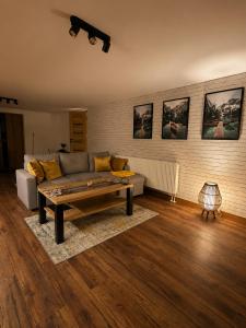 a living room with a couch and a coffee table at Pretty House in Słupsk