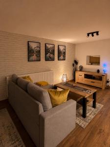 a living room with a couch and a table at Pretty House in Słupsk